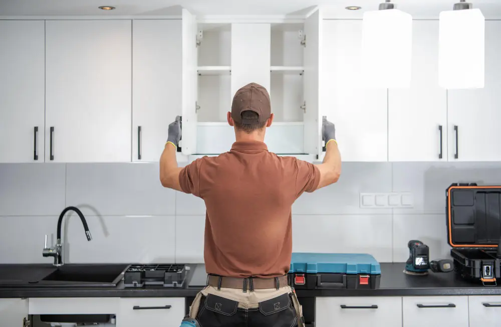 Professional kitchen cabinet installation in Melbourne with wall cabinets being fitted